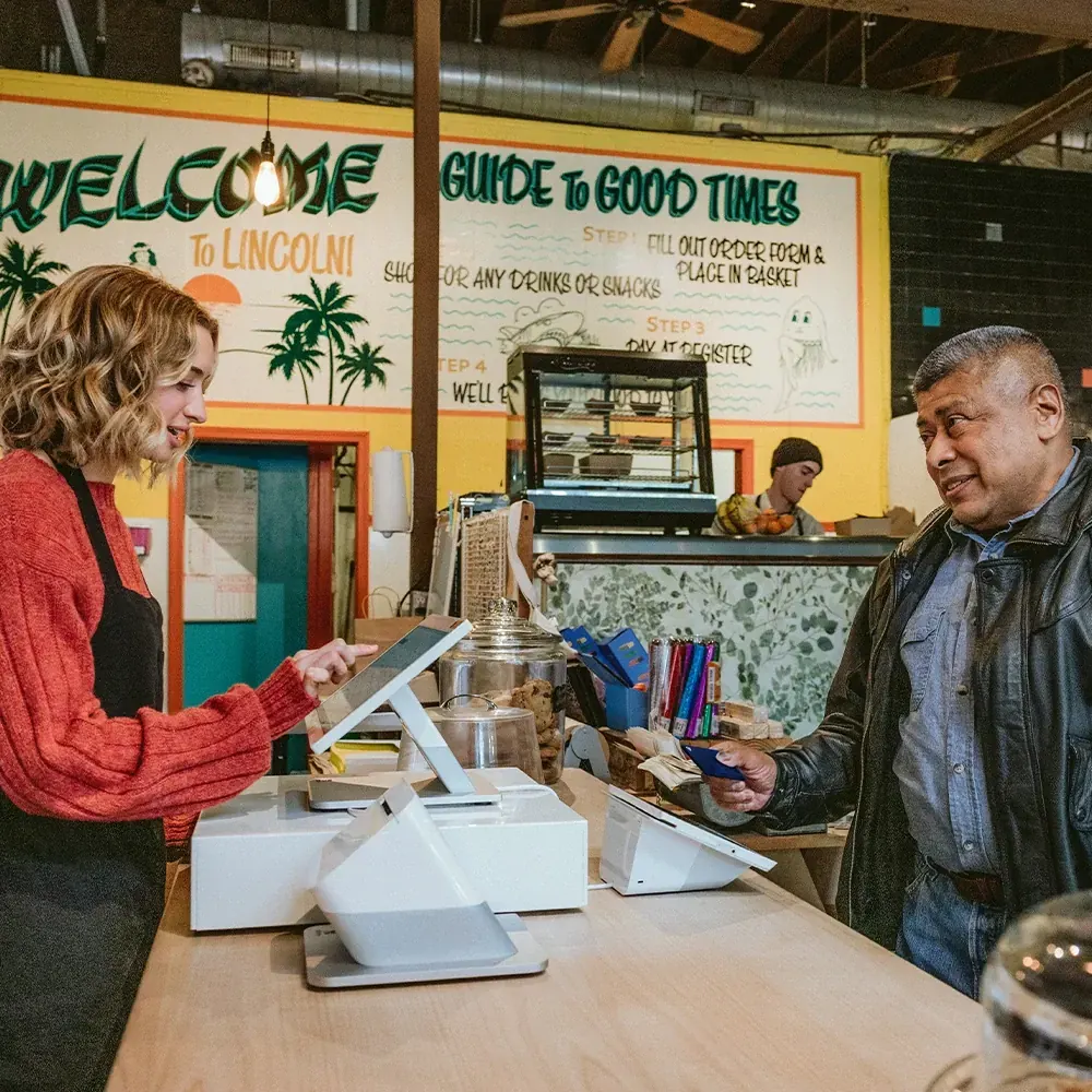 Corner store counter with a countertop POS and customer-facing display